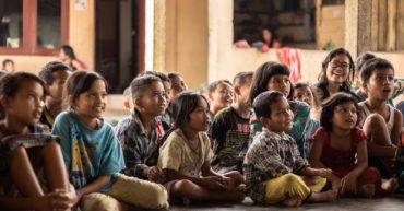 group of childrens sitting on ground